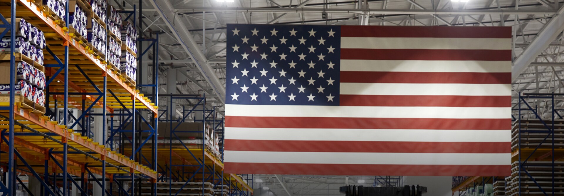 An American flag hangs inside a GAF manufacturing facility where SkillBridge trainees gain skills for civilian careers.