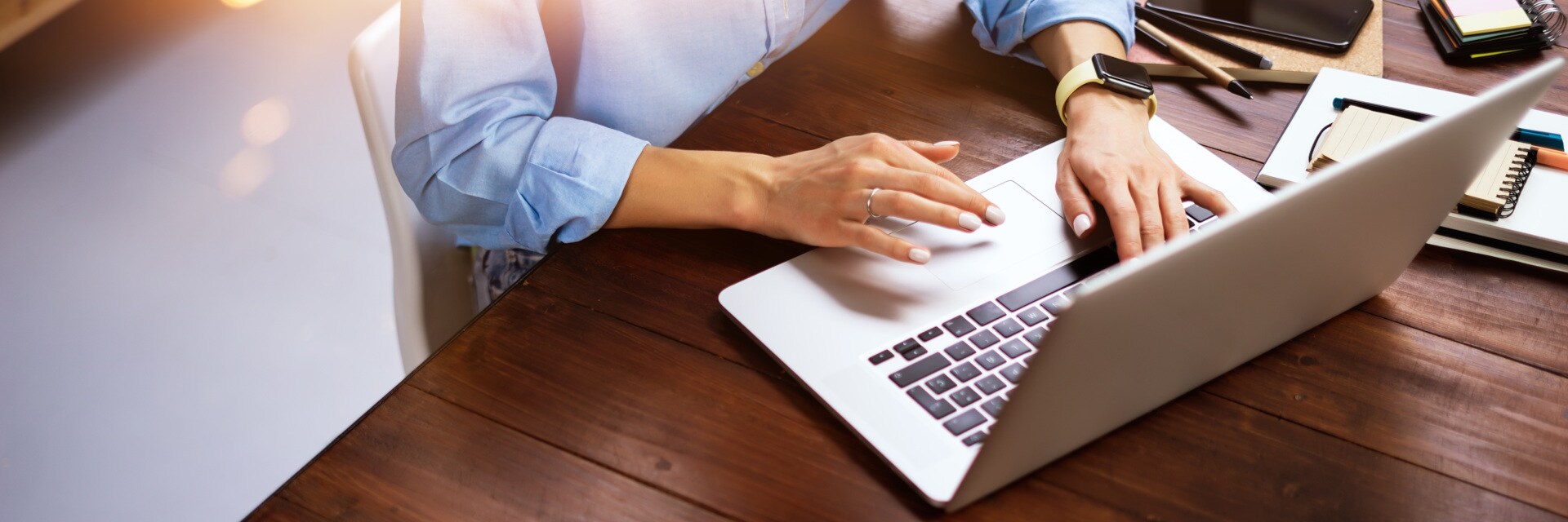 Blogger writing a new article at a wooden desk.
