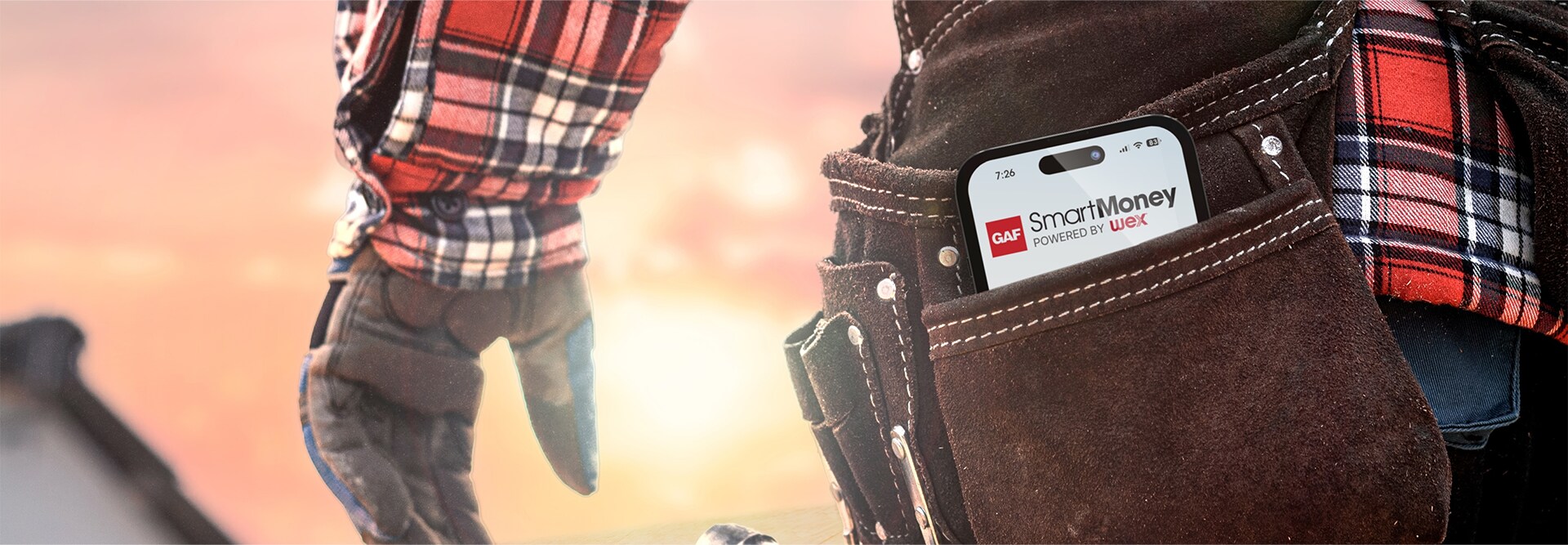 Smartphone showing GAF SmartMoney app in a leather tool belt worn by a GAF certified contractor.
