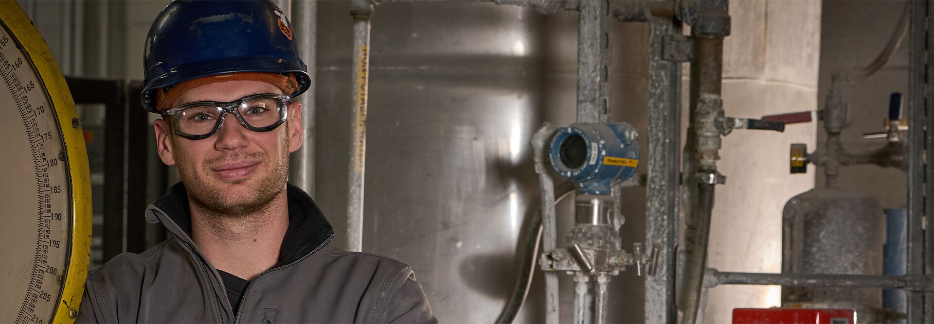 GAF employee wearing a hard hat and a GAF brand jacket at the Minneapolis plant.