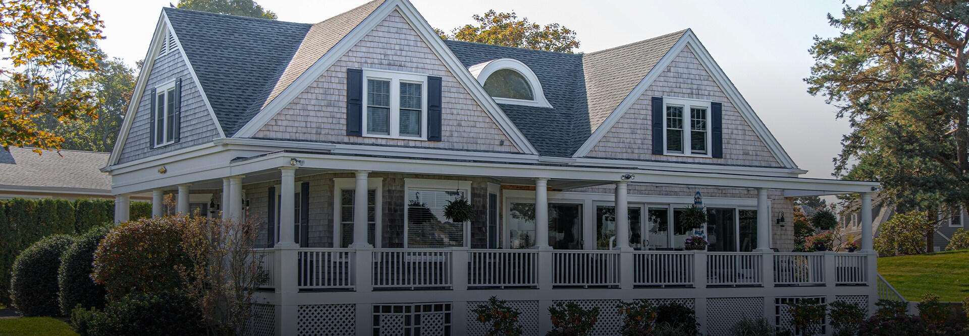 Home with a front porch and gray roof installed by a GAF National Circle™  roofing contractor.