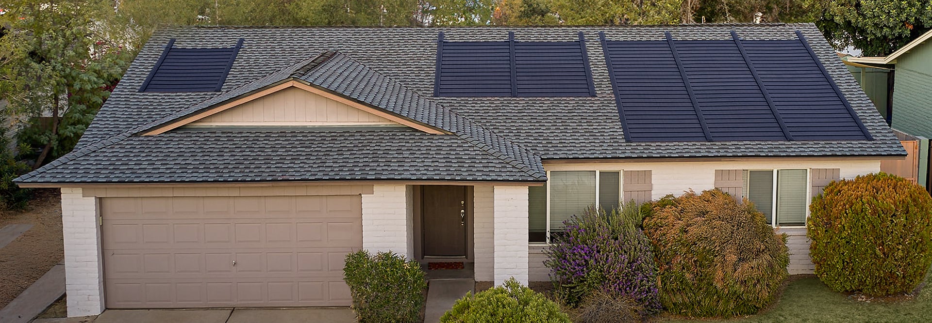 Aerial view of a Timberline Solar Roof System on a house