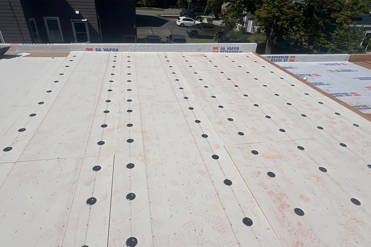 Layers of the GAF flat roof system being installed on the Getty Bagel Shop in NH.