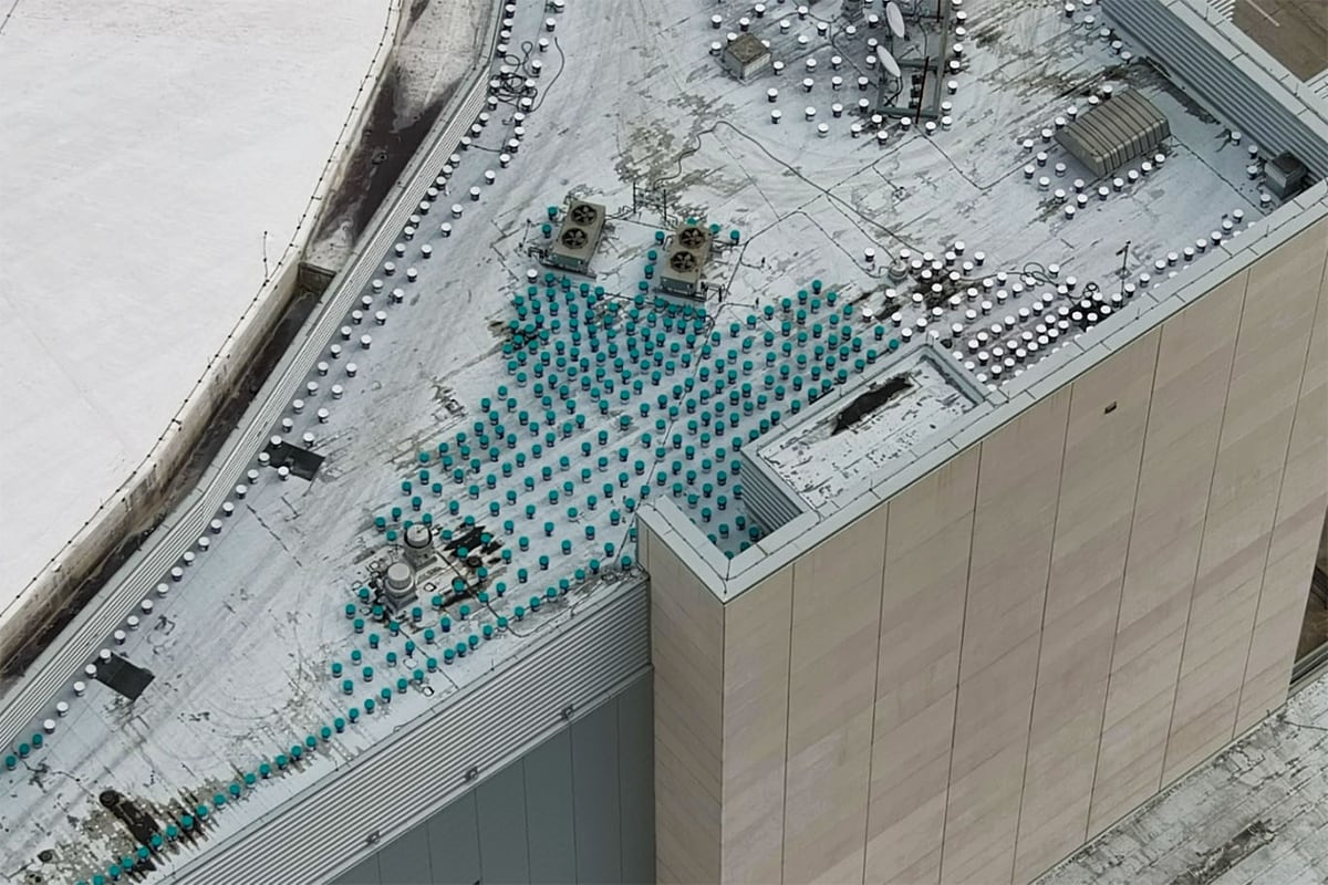 Buckets of GAF liquid-applied roofing materials ready for installation on the dome roof of the Kia Center in Orlando.