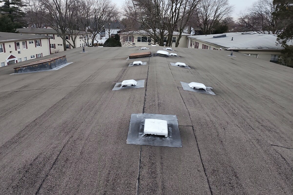 Close-up of the aging roof system on the Post House, before a GAF Chairman’s Circle contractor completed a roof recovery.