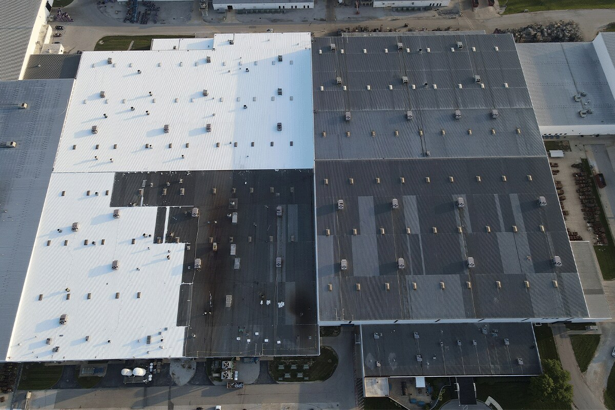 Aerial view the metal roof on the TOA USA facility showing half of the roof with new GAF roof coating solution.