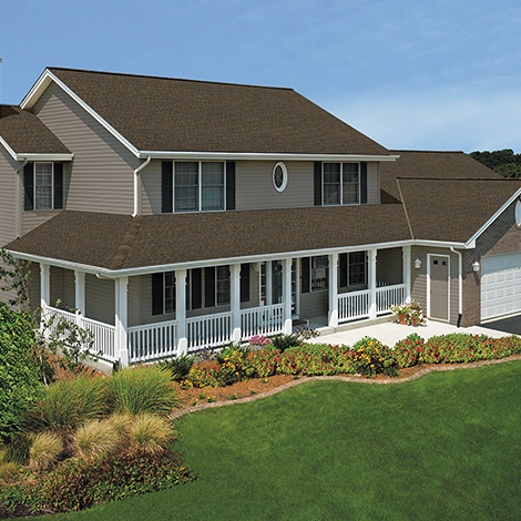 A house featuring GAF-manufactured Barkwood shingles on its roof.