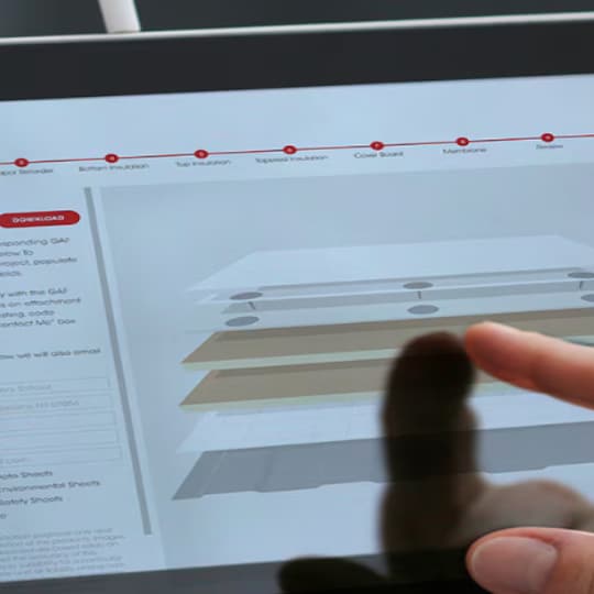 Roofing professional using GAF commercial roofing system design tool on a tablet