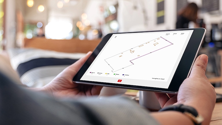 Tablet with GAF QuickMeasure roof measurement software open with commercial roof outline