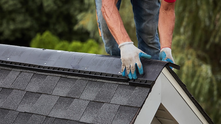 GAF certified contractor installing a GAF brand ridge vent on top of a roof