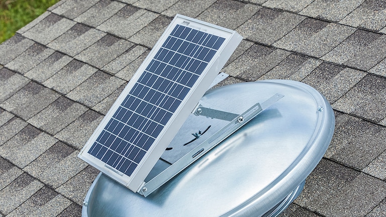 A GAF solar vent installed on an asphalt shingle roof