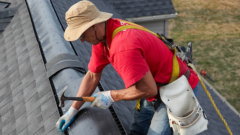 Contractor attaching a strong roof vent as part of the Fortified roof system