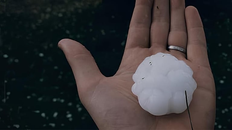 Up close shot of hand holding an ice ball.