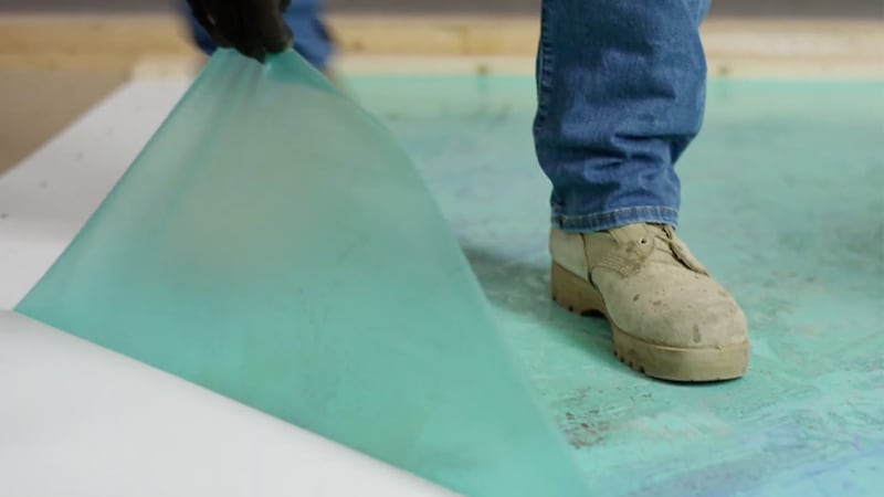 Contractor pulling back the MembraneShield film