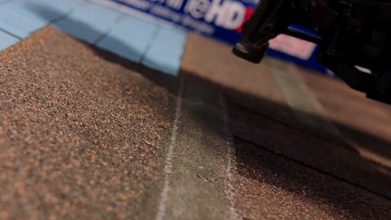 Video thumbnail showing a close up of Timberline HDZ shingles being nailed onto a roof.