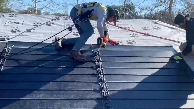 Video thumbnail showing solar certified roofers demonstrating how to install the Timberline Solar TLS-1 shingles.