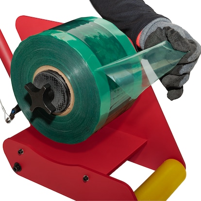 A commercial roofer loading a roll of seam film into the EverGuard MembraneShield™ Seam Film Applicator.
