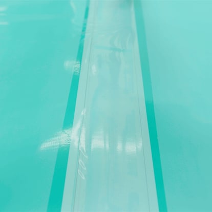 A row of the Seam Film covering the exposed TPO surface of a flat roof.

