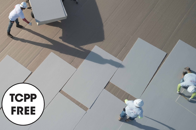 Three GAF contractors laying down and aligning TCPP-free NH polyiso products with TCPP free icon

