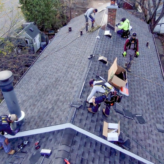Roofing contractors installing GAF products on a veteran’s roof