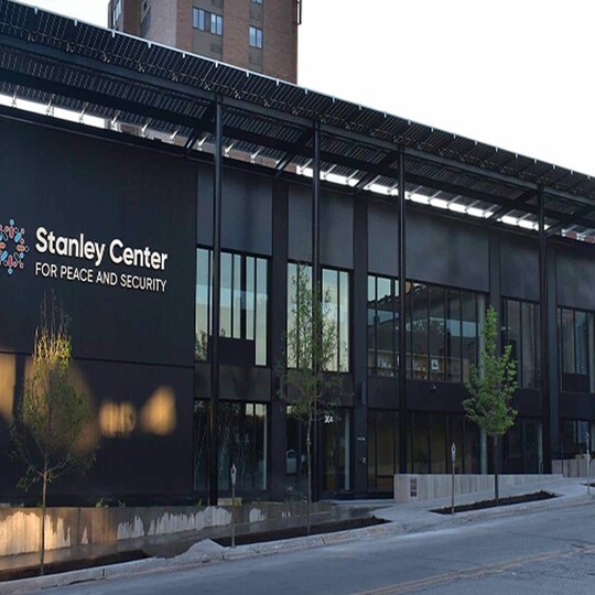 Modern green building with "Stanley Center for Peace and Security" logo.