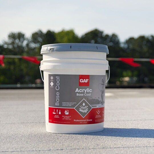 A container of GAF Acrylic Top Coat on a flat roof