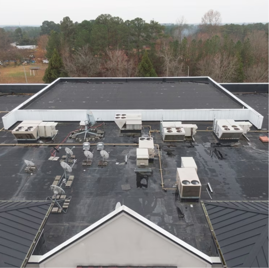 Aerial view of a large commercial roof that had a protective roof coating applied.