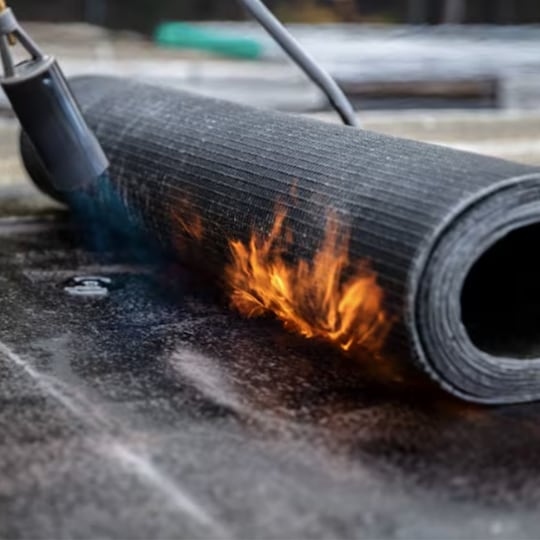 A contractor performs torch down roofing.