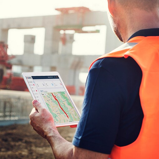 A GAF certified contractor using YARDZ software on a tablet.