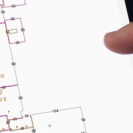 Architects’s finger tapping on a screen showing grid paper