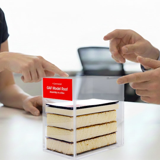 A GAF certified commercial contractor discussing a commercial roof assembly with a client.