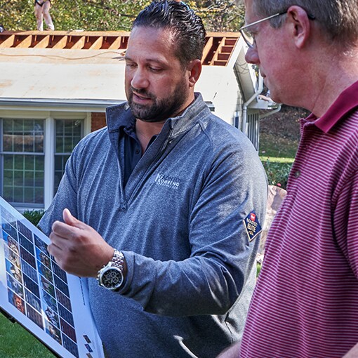 A GAF Master Elite certified contractor talking to a homeowner about shingle options
