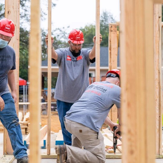GAF employees and leadership working to help build resilient shelter for local families.