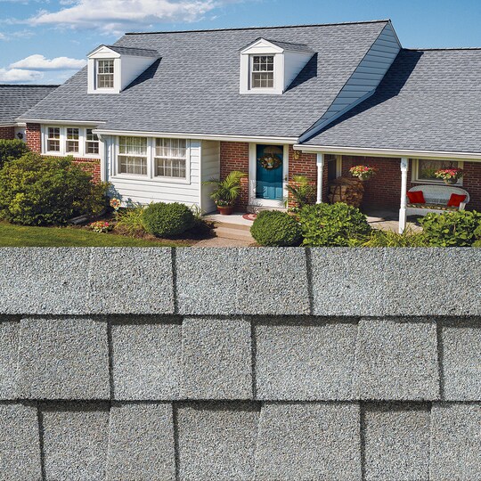GAF Timberline HDZ®  Fox Hollow Gray Shingle closeup with sample product image on a brick house.