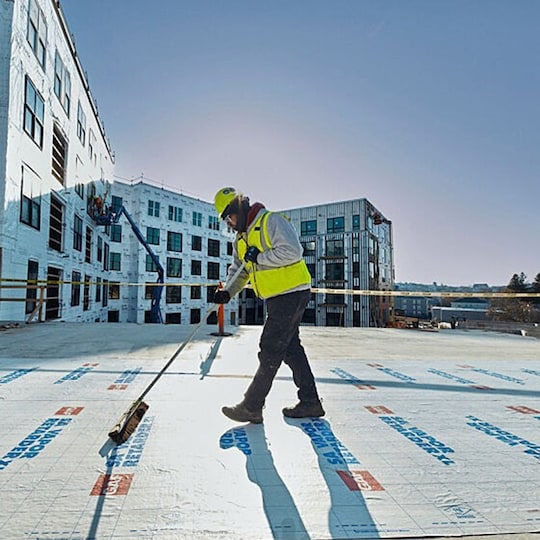 GAF certified commercial roofing contractor installs GAF product on a flat roof.