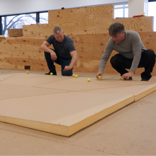Two men working with GAF tapered insulation