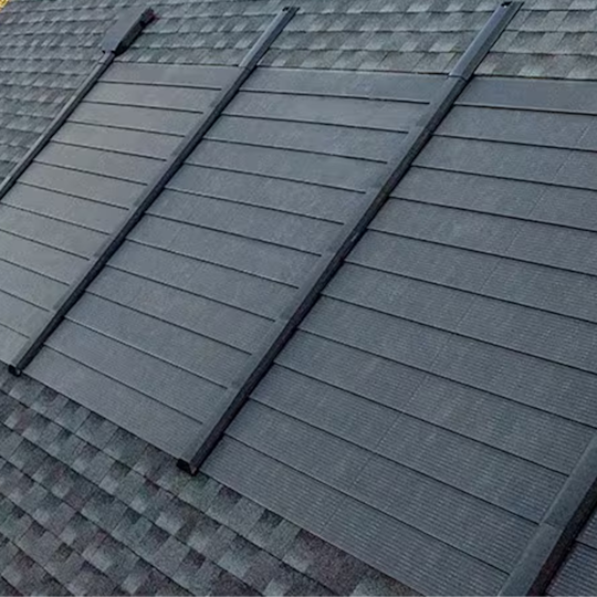 A side view of a house roof featuring solar panels installed as part of GAF’s Timberline Solar roof system