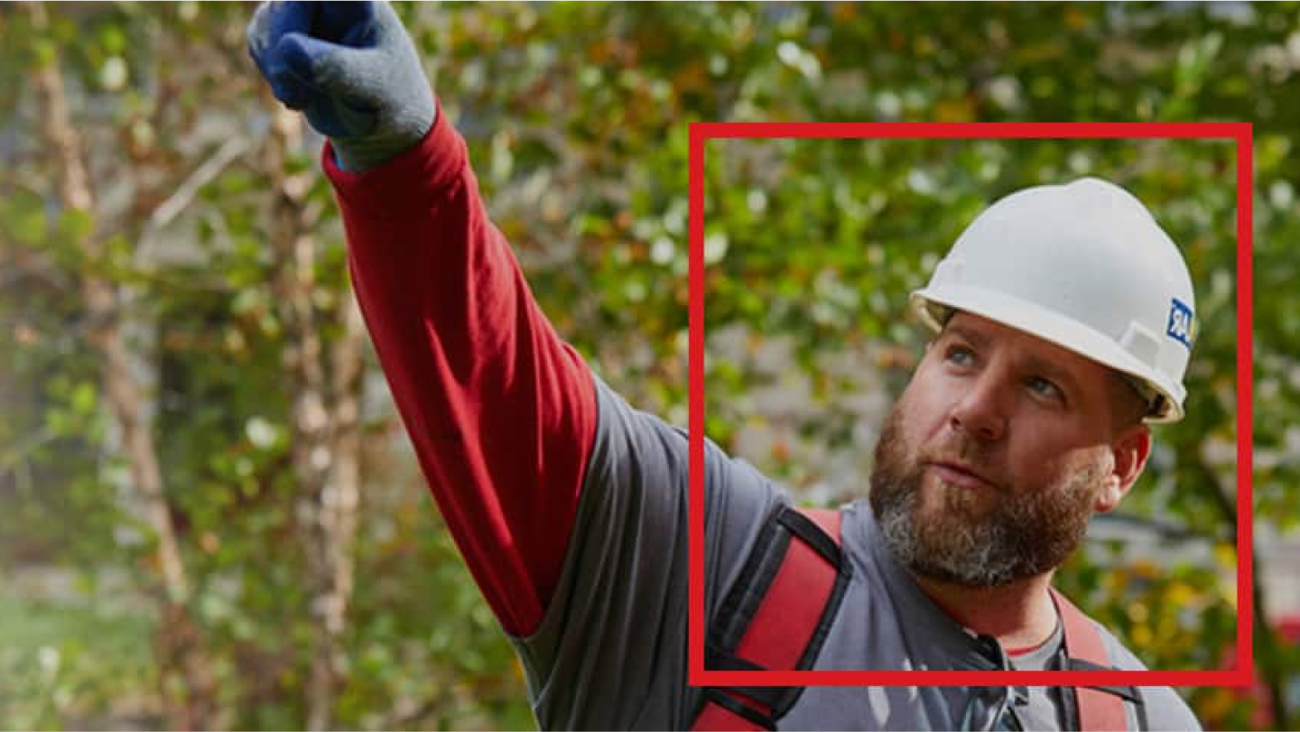 gaf-contractor-wearing-a-white-hard-hat-pointing