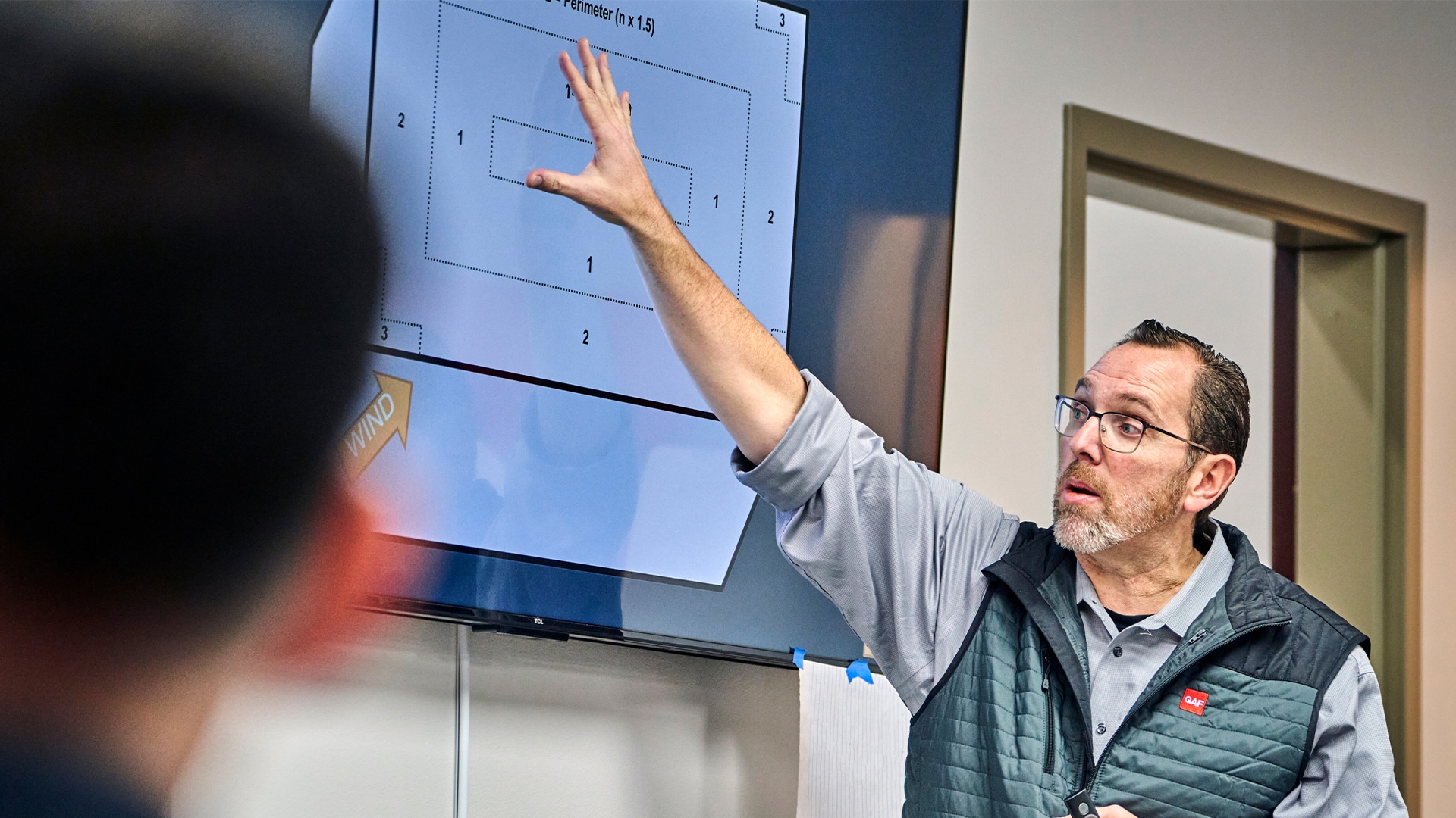 Roofing professional from GAF CARE Contractor training center showing diagram on screen