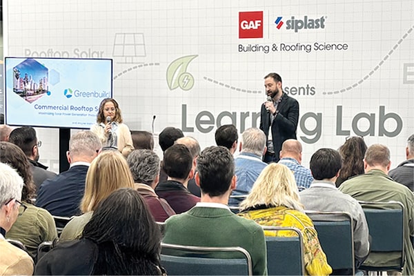 Presenters speak to an audience at a GAF and Siplast Building & Roofing Science "Learning Lab" event focused on commercial rooftop solutions.