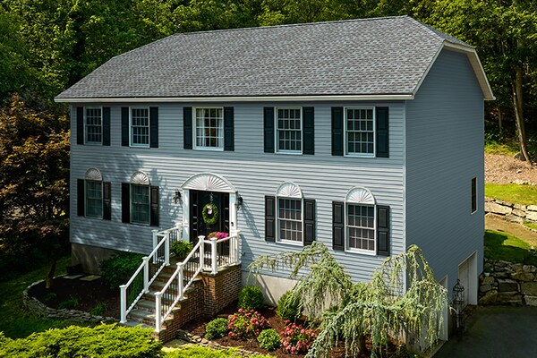 Light blue house with Timberline HDZ® Shingles in Pewter Gray.