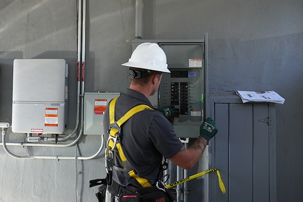 A technician from GAF Energy Services works on an electrical installation as part of support offered to home builders and developers. 