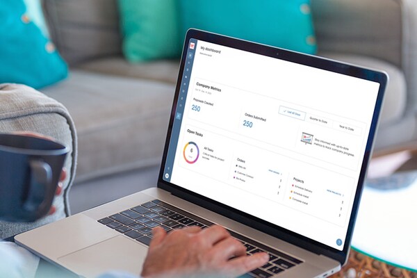 A contractor accessing the  GAF Energy Partner Portal on a laptop. 
