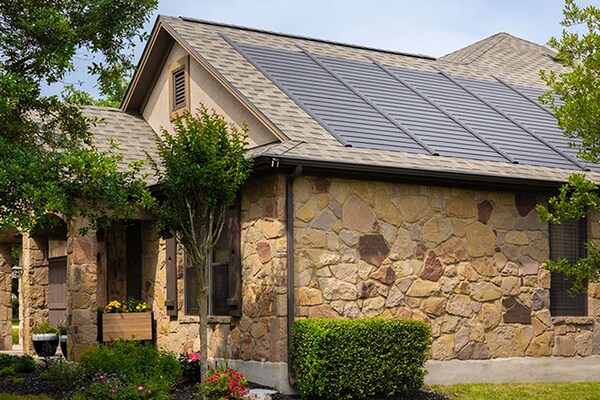Side view of a gray roof with the Timberline solar roof system, which was installed by a home development company.