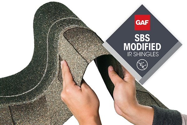 Hands bending a strip of Timberline ArmorShield II shingles, showing how flexible and durable it is.