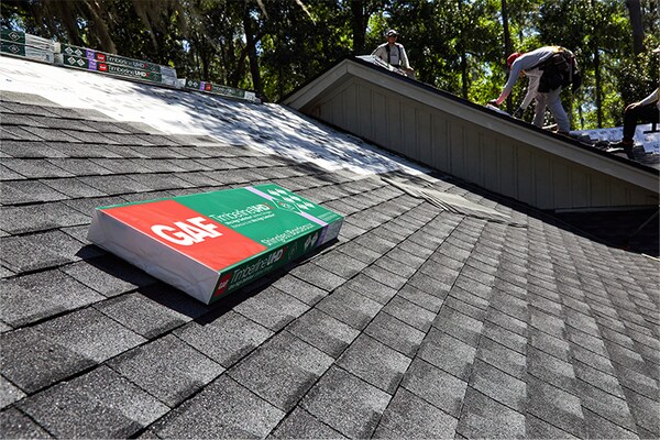 A package of GAF Timberline shingles on top of a roof in the middle of a roof replacement installation.
