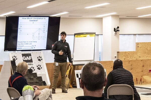 GAF employee leading a class on roofing excellence