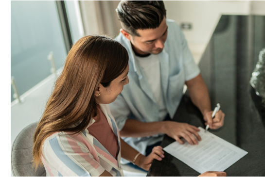 Homeowners signing warranty paper