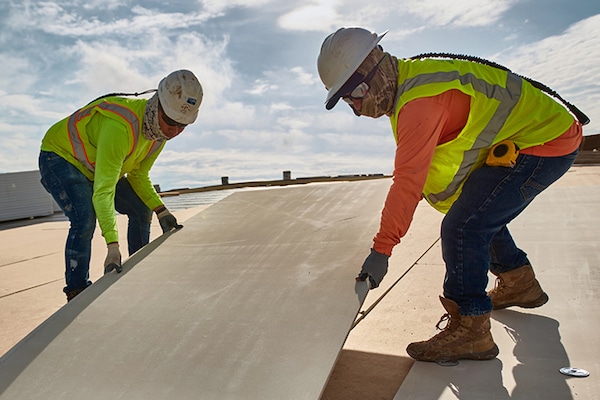 GAF certified commercial roofing contractors installing boards