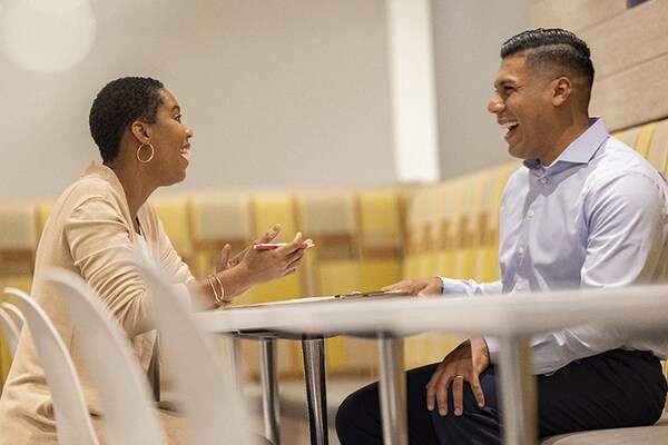 A Wells Fargo representative talking to a roofing contractor about financing options for homeowner customers. 